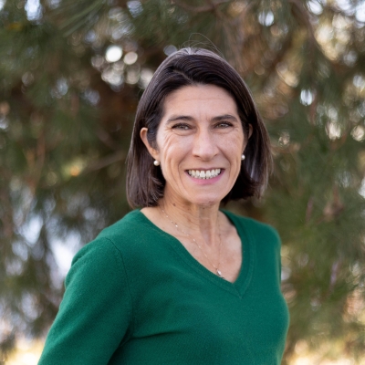 Headshot of a woman with short hair smiling