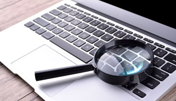 Laptop with magnifying glass